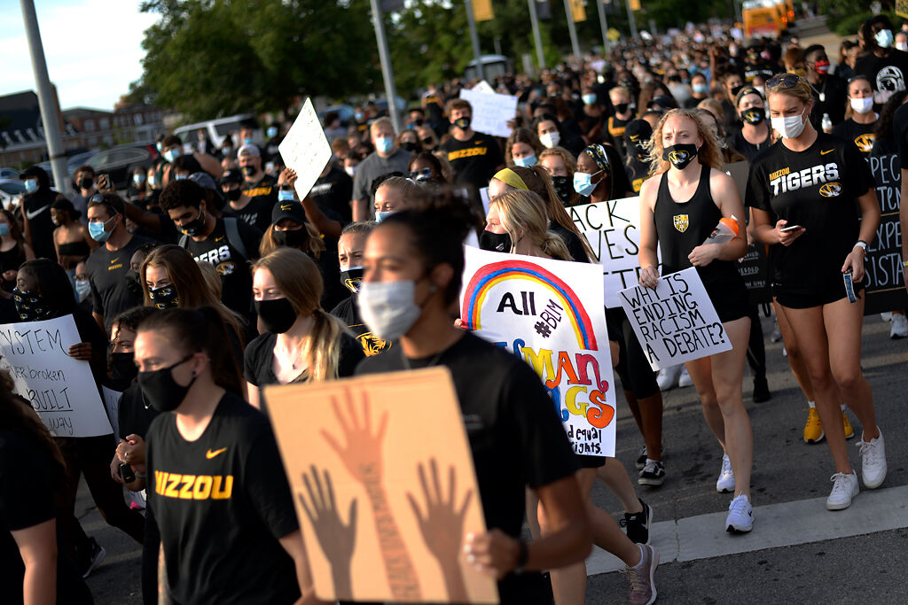 March with Mizzou crowd walks towards Faurot Field on Wednesday